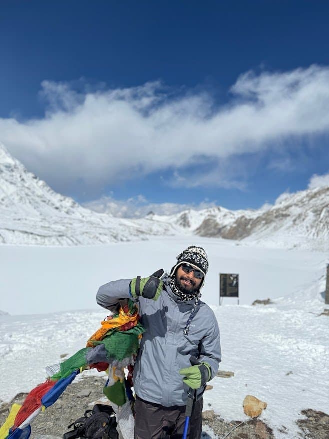 At frozen Tilicho Lake with prayer flags